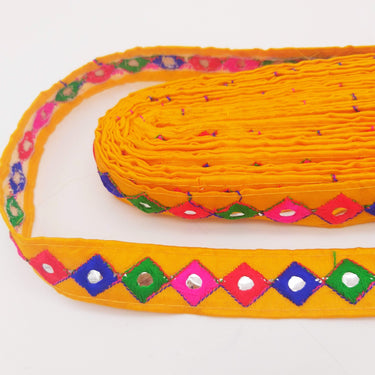 Wholesale Yellow Cotton Fabric Mirrored Trim With Embroidery In Fuchsia Pink, Blue, Red & Green Threads